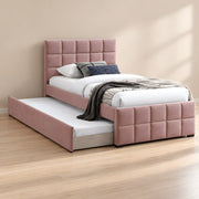 Cemaliso Dusty Pink Kids Trundle Bed displays dusty pink upholstery together with white bedding beside a bedroom window.