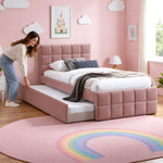 Cemaliso Dusty Pink Kids Trundle Bed, white bedding and dusty pink upholstery, beside a woman making the pull-out bed.
