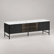 Chestiko White Marble Top TV Unit in a softly lit studio, showing fluted black drawers alongside straight cabinet edges.