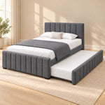 Chikilora Dark Grey Kids Trundle Bed combines vertical padded channels with dark grey upholstery in a furnished bedroom.