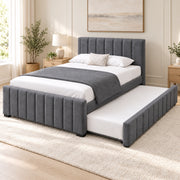 Chikilora Dark Grey Kids Trundle Bed in a furnished bedroom, featuring a channelled footboard and dark grey upholstery.
