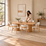 Close-up of Colioaky Wooden Oval 6-Seater Dining Table, highlighting oval top with rounded ends in a modern home setting.