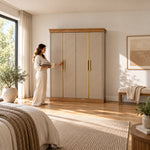 Dolbarino 4 Door Wooden Wardrobe, chevron-patterned doors and a wood-tone base, with a woman standing beside the cabinet.