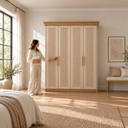 Dolbarino 4 Fluted Door Wooden Wardrobe with four vertically fluted doors, beside a woman reaching toward the door.