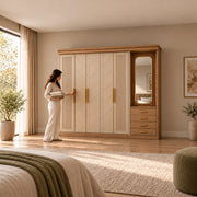 Dolbarino 5 Door Wooden Wardrobe with Vanity with a woman standing beside the cabinet; fluted doors and an adjoining mirror.