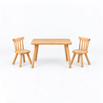 Dukyshola Wooden Kids Table with 2 Chairs in a straight-on view, showing spindle-back chairs alongside splayed round legs.