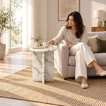 Additional view of Gizimora Marble Side Table, showing round top and light marble-look appearance in a modern home setting.