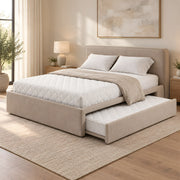 Hensylona Taupe Kids Trundle Bed displays taupe upholstery together with a plain padded headboard against a bedroom wall.