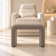 Hoksala Upholstered Pedicure Footrest, showing padded panel legs and rounded upper corners at a sunlit pedicure station.