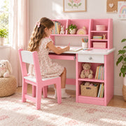 Homkona Pink Kids Study Desk with Chair: a pull-out keyboard tray beside a child seated at the table on a patterned rug.