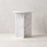 Inolisy White Marble Side Table featuring an intersecting slab base in a clear product photograph in a modern home setting.