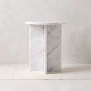 Inolisy White Marble Side Table featuring an intersecting slab base in a clear product photograph in a modern home setting.