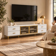 Kavonsa White Marble Top TV Unit, four side drawers and a white marble top, beneath a wall-mounted TV with a woman nearby.