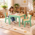 A child draws at the Kidmesho Kids Table with 2 Chairs, showing mint-green frames, pale wood seats and a square tabletop.