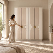Lottomira 4 Door Wooden Wardrobe, a four-door front and curved panel detailing, beside a woman reaching toward the door.