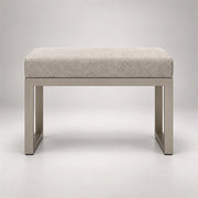 Lupendri Pedicure Footrest in a softly lit studio: a taupe metal base, open sled-style legs and square-profile supports.