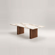 Mackilti Marble Top 6-Seater Dining Table, with two fluted panel legs and a long dining surface against a grey backdrop.