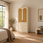 Mossylora Cane Cabinet Storage with Three Drawers pairs leaf-shaped pulls with a cream cabinet frame in a sunlit bedroom.