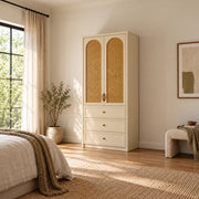 Mossylora Cane Cabinet Storage with Three Drawers pairs leaf-shaped pulls with a cream cabinet frame in a sunlit bedroom.