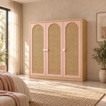 Natupiny 3 Door Rattan Cane Wardrobe with white heart-shaped pulls and three arched cane panels beside a bedroom window.