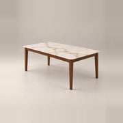 Olzenro Marble Top 6-Seater Dining Table, with tapered walnut-brown legs and a warm wooden apron against a grey backdrop.