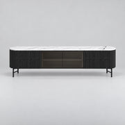Raveliono White Marble Top TV Unit: dark glass centre storage, slim black legs and rounded ends against a grey backdrop.