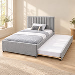 Sillavony Light Grey Kids Trundle Bed, showing a plain padded footboard and light grey upholstery against a bedroom wall.