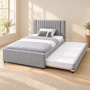 Sillavony Light Grey Kids Trundle Bed, showing a plain padded footboard and light grey upholstery against a bedroom wall.