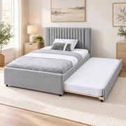 Sillavony Light Grey Kids Trundle Bed pairs a plain padded footboard with narrow headboard channels in a sunlit bedroom.