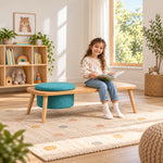 Stepsoly Kids Wooden Floor Table with Pouf: rounded tabletop corners beside a child seated with a book on a patterned rug.