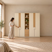 Stylonsy Wooden Wardrobe with Shelves and Drawers with a woman standing beside the cabinet, showing circular door pulls.