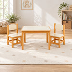 Tischona Kids Table with 2 Chairs on a patterned playroom rug, featuring ivory chair seats and two matching wood chairs.