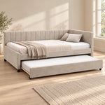 Twincelo Taupe Kids Trundle Bed shown with a channelled back, small dark feet and taupe upholstery in a sunlit bedroom.