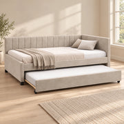 Twincelo Taupe Kids Trundle Bed shown with a channelled back, small dark feet and taupe upholstery in a sunlit bedroom.