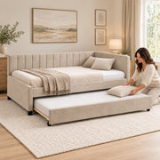 Twincelo Taupe Kids Trundle Bed, unequal-height end arms and small dark feet, with bedding being arranged on the trundle.