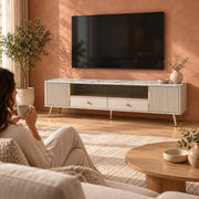 Vendrilosa White Marble Top TV Unit with a woman beside the living room media wall, showing dark glass centre doors.