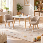 Vevory White Kids Table with 2 Beige Chairs beside a playroom window, showing light wood legs alongside white-tipped feet.