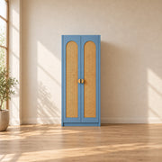 Webinora Blue 2 Door Wooden Cane Wardrobe brings together two blue doors and a narrow cabinet body against a bedroom wall.