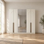 Weltwiyo 6 Door Wooden Wardrobe displays pale full-height doors together with a broad wardrobe frame in a furnished bedroom.