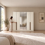 Weltwiyo 6 Door Wooden Wardrobe in a sunlit bedroom, with long wood-tone handles and a woman beside its reflective centre.