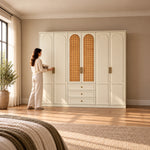 Wratinora 6 Door Wooden Wardrobe with Drawers with a woman at the front of the wardrobe, showing central cane panels.