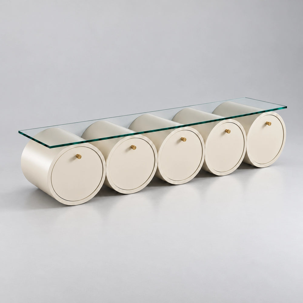 Zoverina Cream Glass Top TV Unit, showing small gold-tone knobs and cream cylindrical sections against a grey backdrop.
